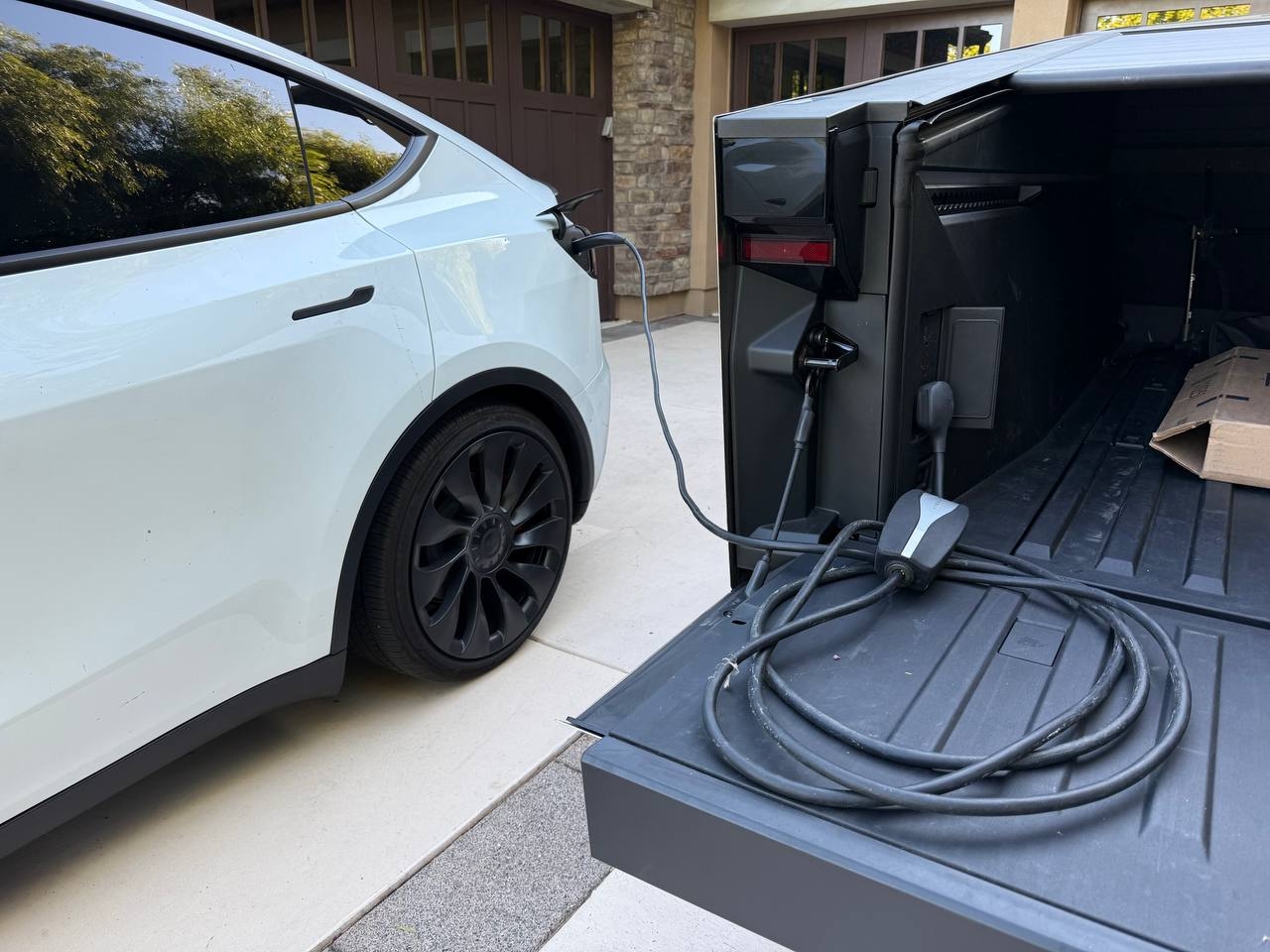 Tesla Cybertruck charging another Tesla